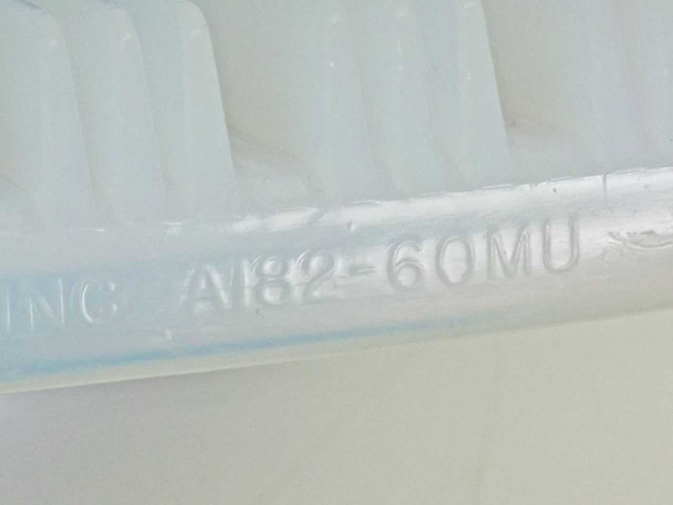 Close-up of A182-60MU part number molded into the white 13-slot cassette insert