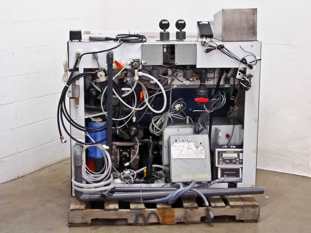 Rear view of ITS wafer mask cleaner developer system showing complex wiring, fluid plumbing, Grundfos pump, compressor, and breakout box