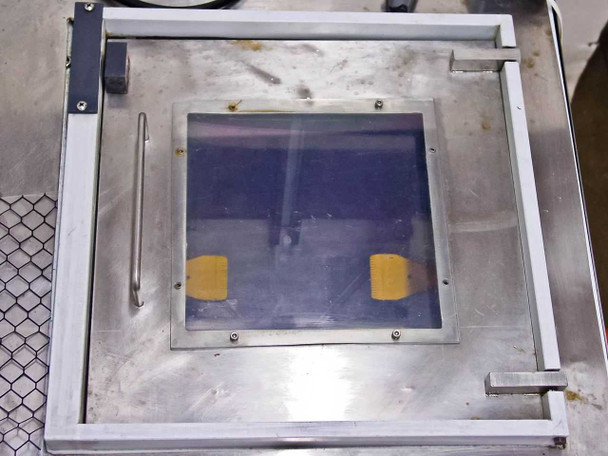 Wafer mask cleaner process chamber top view through transparent lid showing stainless steel frame and yellow wafer/mask holders