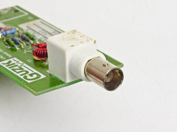 Close-up of white BNC connector on Guzik C-201 Head Calibrator PCB showing center pin and coupling nut detail