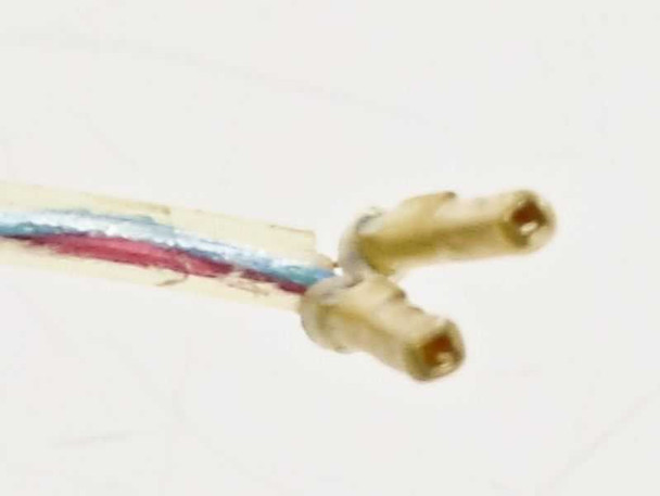 Close-up of multi-wire harness on Guzik C-201 calibrator showing two crimp pin female terminals on red, blue, and white wires