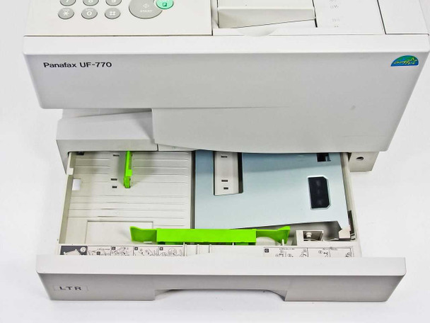 Panasonic UF-770 LTR paper cassette drawer open showing paper guides and loading area with green and grey adjusters