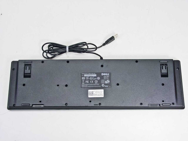 Dell KB1421 keyboard bottom view showing rating label, fold-out feet, and USB cable