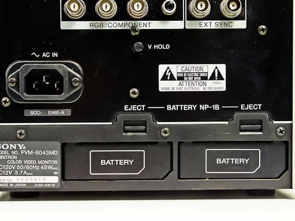 Sony PVM-8043MD rear panel lower section showing dual NP-1B battery bays with eject buttons, AC inlet, V Hold control, and Sony model/serial number label