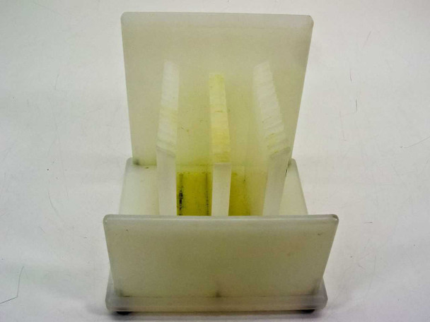 Front-on view of the 12-slot wafer holder showing slot dividers and internal vertical support posts, no wafer inserted