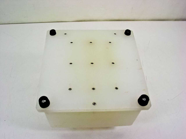 Bottom view of the HDPE wafer carrier showing flat base plate with four black rubber feet and multiple fastener screws securing the base assembly