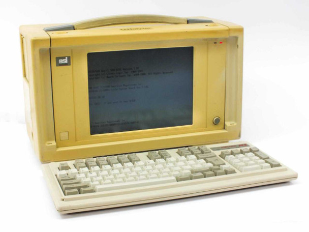 Novell LNalyzer BSI 386DX-33 portable lunchbox PC — three-quarter front view with keyboard deployed, unit powered on showing DOS text on screen