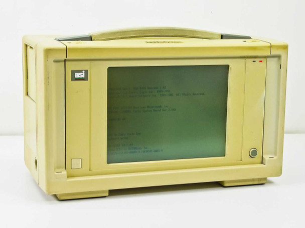 Novell LNalyzer BSI 386DX-33 lunchbox computer — front view powered on showing DOS boot screen on built-in CRT