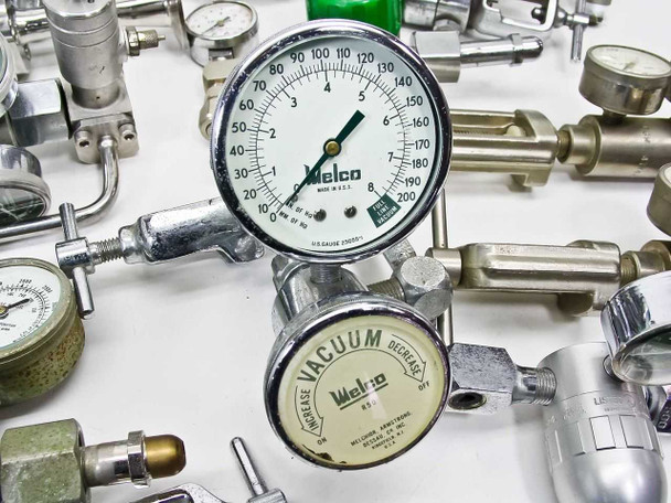 Close-up of Welco 0–200 PSI pressure gauge and Welco vacuum regulator (Increase/Decrease dial) with surrounding chrome valves and gauges visible in background