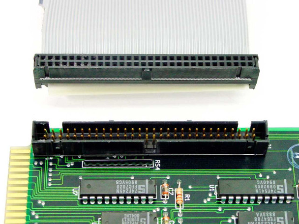 Cubix A2430 interface card closeup showing 60-pin IDC connector and ribbon cable connector aligned — component detail view