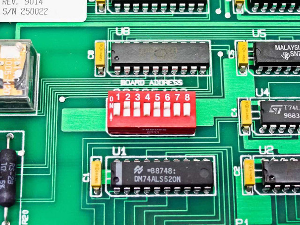 Close-up of board address DIP switch and DM74ALS520N IC with REV 9014 and S/N 250022 label visible