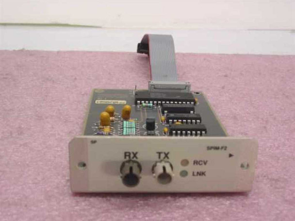 Cabletron SPIM-F2 fiber optic module front panel showing RX and TX ST connectors with RCV and LNK indicator LEDs and attached ribbon cable