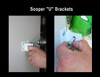 A step-by-step view of the installation process. The photo shows a sign being mounted securely using the Sooper "U" Brackets, demonstrating how the brackets attach the solid substrate between posts.