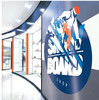 A storefront in a mall showcases the versatility of DryTac RETAC® SMOOTH 150 MATTE. The material is printed with the store's logo and adhered seamlessly to the glass exterior, demonstrating its ability to create vibrant, professional graphics that are easily repositionable. The smooth matte finish of the film enhances the visual appeal while ensuring a glare-free display, perfect for attracting foot traffic and maintaining brand visibility.
