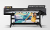 The Mimaki CJV200-75 at work inside a print shop, actively producing a set of colorful vehicle graphics. A technician stands nearby, demonstrating the compact size and ease of use.