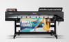 The CJV200-130 actively printing and cutting decals in a commercial print shop. A technician oversees the machine to showcase its user-friendly interface and production speed.