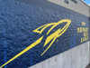 DPF V9500 applied to a textured brick wall with vibrant print graphics and seamless edge conformability.