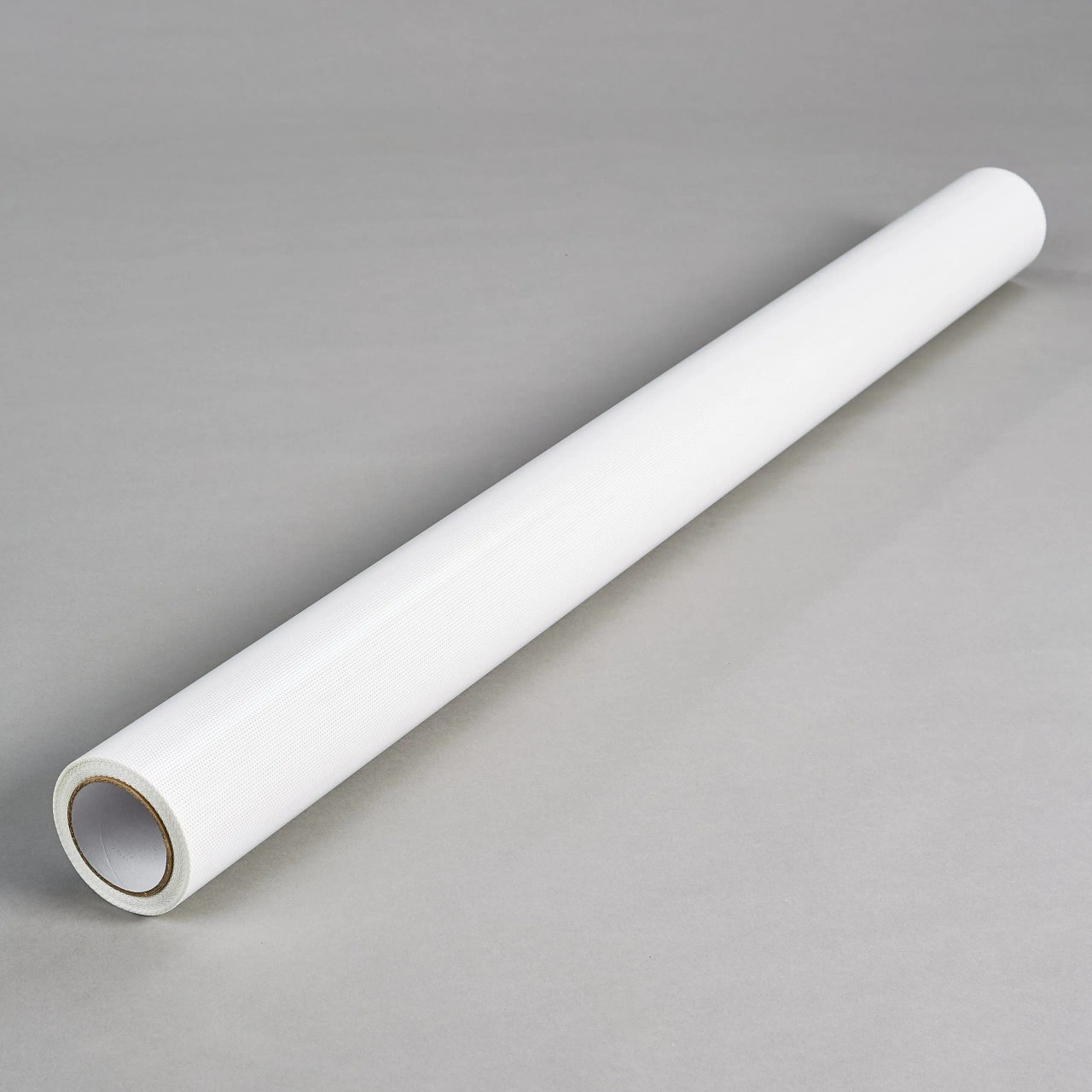 A roll of Contra Vision Campaign Clear 70/30 Window Perf film in its original roll form. The roll is tightly wound, showing the clear perforated vinyl ready for printing. The part-perforated paper/plastic liner is visible, indicating the film’s readiness for use with various printing technologies including UV-cure, solvent, eco-solvent, and latex inkjet printing, as well as screen printing.