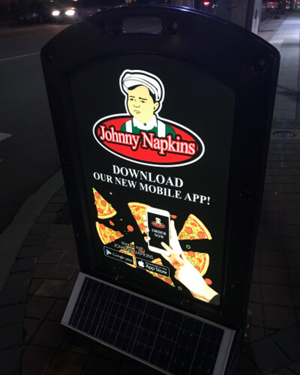 A vibrant night scene of a pizza restaurant illuminated by the Sun Sign display. The bright LED lighting ensures the restaurant's name and specials are clearly visible, attracting customers even after dark.