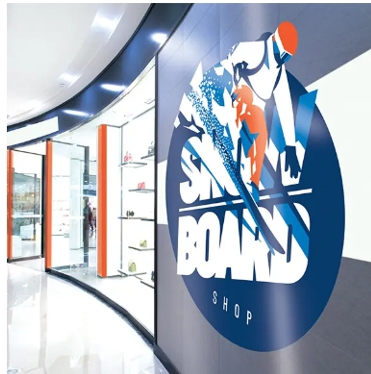 A storefront in a mall showcases the versatility of DryTac RETAC® SMOOTH 150 MATTE. The material is printed with the store's logo and adhered seamlessly to the glass exterior, demonstrating its ability to create vibrant, professional graphics that are easily repositionable. The smooth matte finish of the film enhances the visual appeal while ensuring a glare-free display, perfect for attracting foot traffic and maintaining brand visibility.