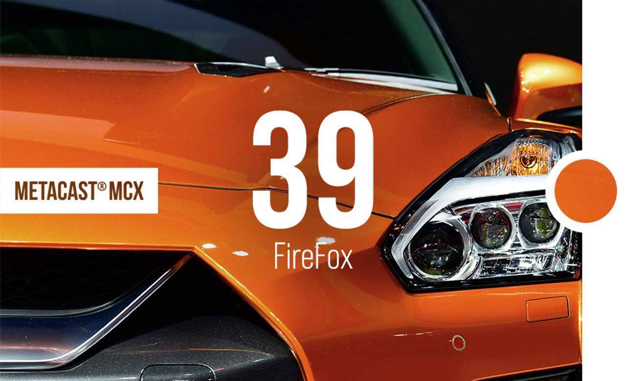 A stunning sports car wrapped in Gloss Metallic FireFox reveals the color's intense, fiery orange glow with a striking metallic finish. The light reflects beautifully off the wrap, highlighting its smooth texture and bold look. The MetaCast® MCX-39 Gloss Metallic FireFox wrap adheres seamlessly to the car’s curves, giving it a sleek and aggressive appearance. This vibrant wrap enhances the vehicle’s dynamic lines, making it stand out in any environment. The durable, high-performance film maintains its vivid color while offering long-lasting protection against the elements.