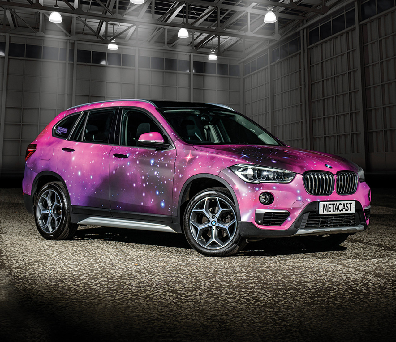 A stunning vehicle wrap showcasing MetaCast® MDC – Performance Redefined Digital Cast Film applied to a sleek car. The vibrant, high-quality print on this premium cast film highlights the film's ability to conform to complex curves, contours, and channels of the car's body, ensuring a flawless, professional finish. The smooth, matte texture of the wrap reflects the film's superior repositionability and high adhesive strength. The MetaCast® MDC wrap enhances the vehicle’s appearance with sharp, vibrant colors, and the film’s ability to adhere seamlessly to challenging surfaces demonstrates its exceptional conformability and ease of application.
