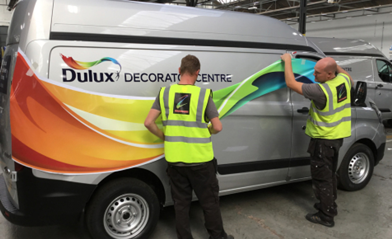 A commercial van showcasing custom graphics printed and installed on MetaWrap MD-XB Cylinder Cast Digital Wrapping Media. The film’s ability to flow and conform to both flat and curved surfaces ensures a smooth, professional application, even around deep channels and recesses. The vibrant, high-quality print stands out with minimal substrate show-through, thanks to the grey blockout adhesive. This van wrap illustrates the film's excellent dimensional stability and brilliant color reproduction, making it a perfect choice for eye-catching fleet graphics.