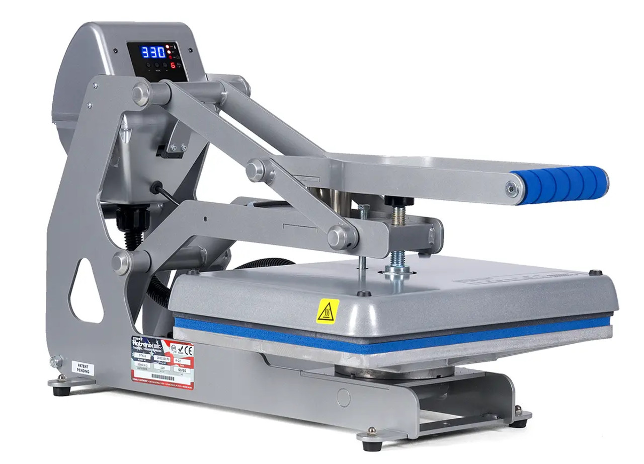 Hotronix Auto Clam Heat Press 11x15 by Stahls' displayed on a workspace with the clamshell open, showing the compact design, digital control panel, and heating platen.