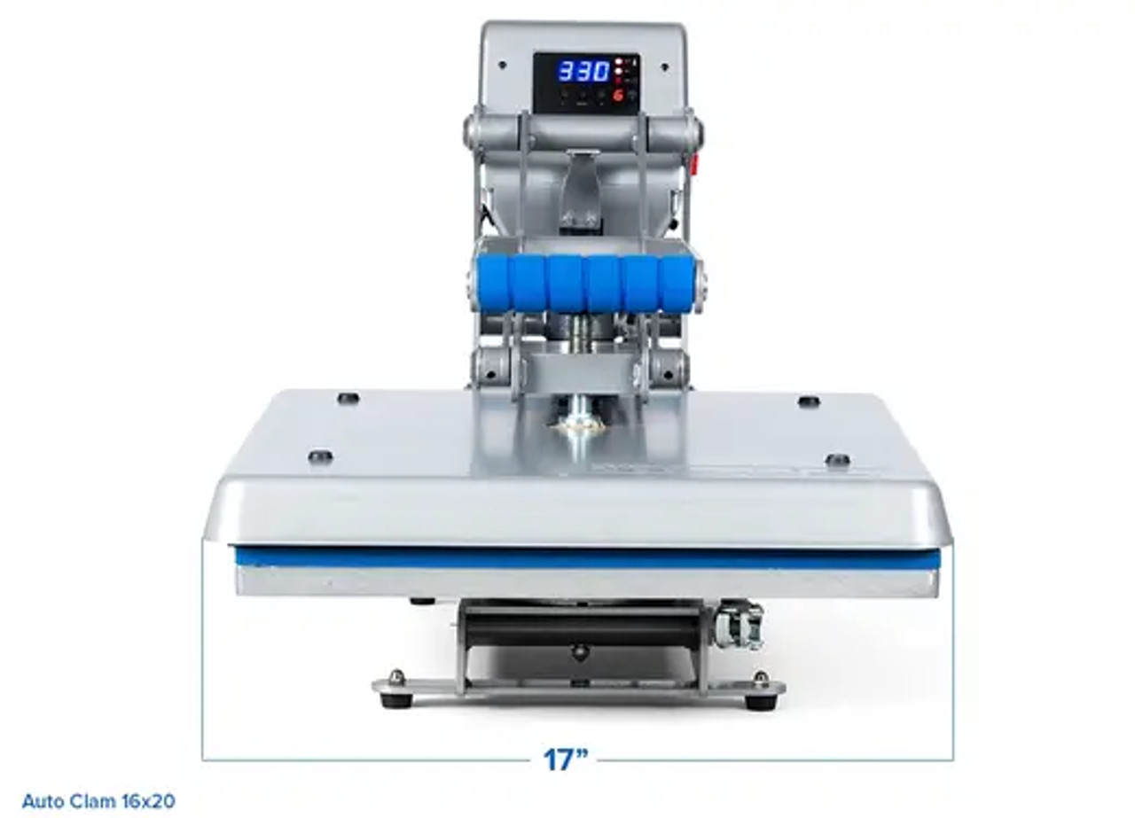 Hotronix® Auto Clam Heat Press 16x20 by Stahls' shown on a print shop table, clamshell open, highlighting its large platen, touchscreen controls, and rugged frame.