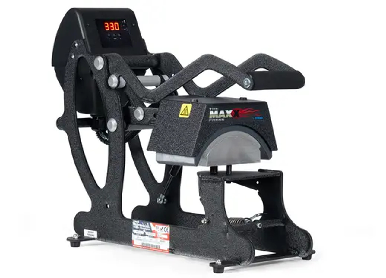The MAXX® Cap Heat Press by Stahls' shown on a worktable with curved lower platen and digital controls—ideal for customizing hats and caps with ease.