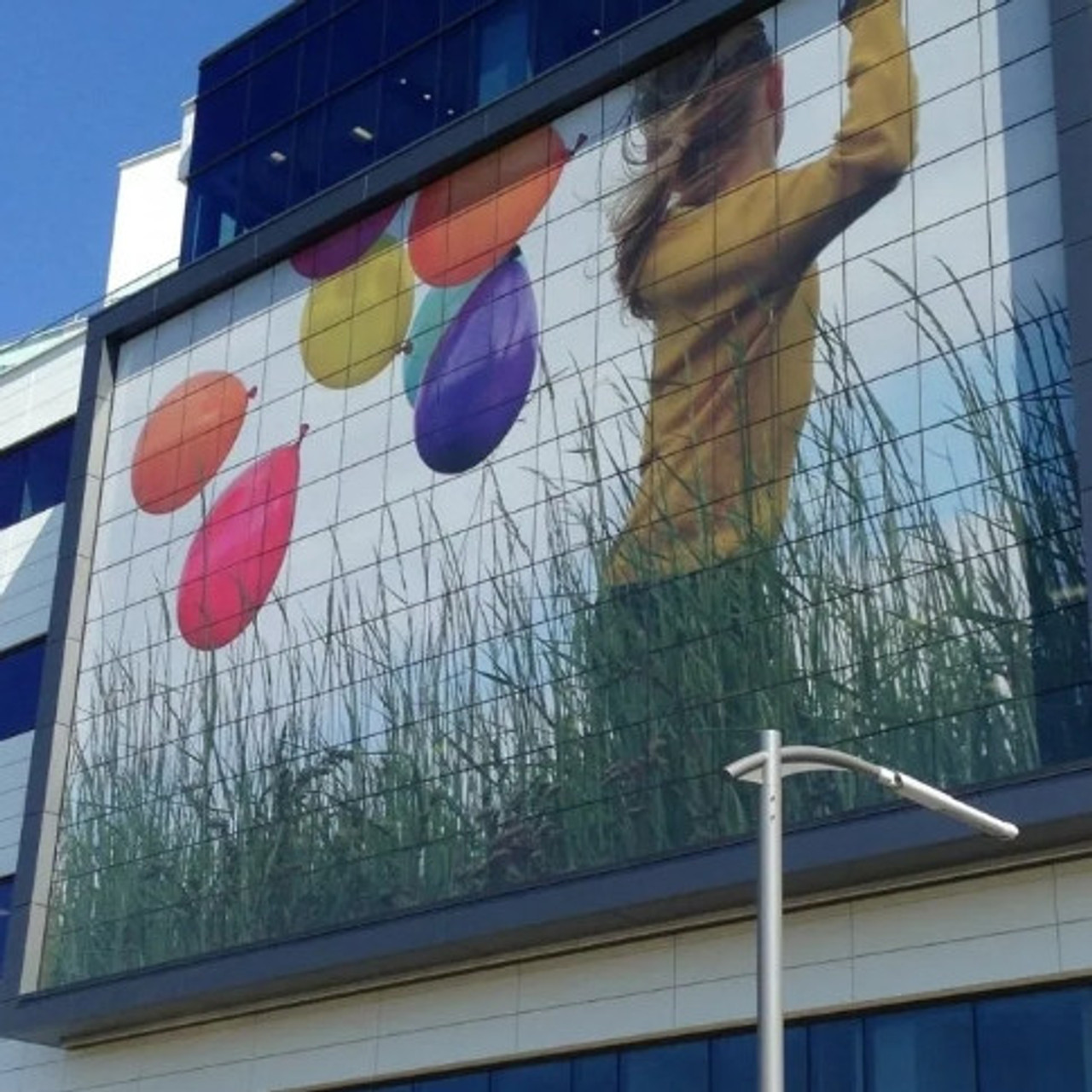 Contra Vision 70/30 perforated window film applied to retail storefront