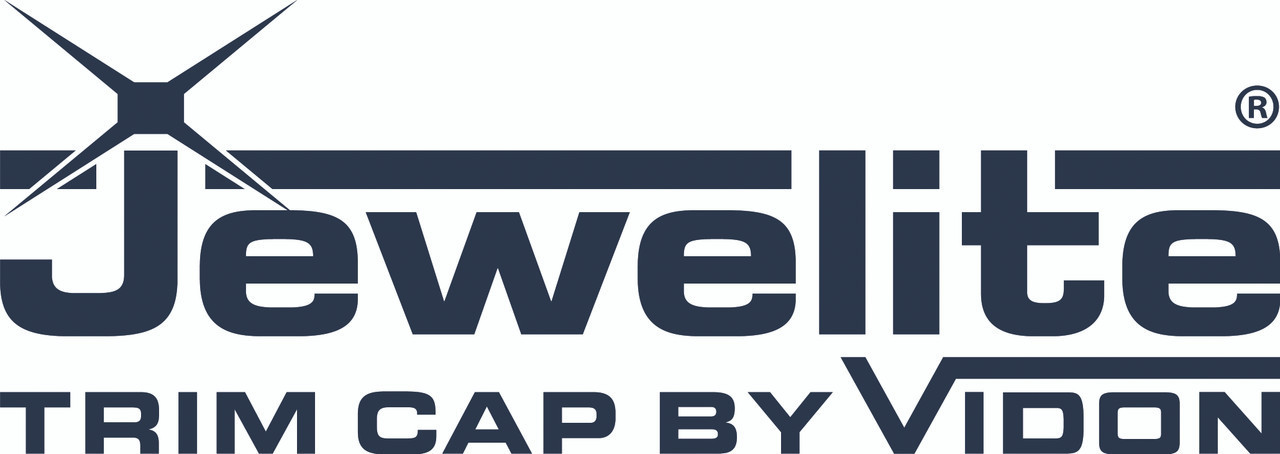 In this image, the Jewelite Trim Cap sample is laid horizontally, offering a detailed view of its overall profile and design features. The photograph clearly captures the trim cap's consistent color, seamless edges, and engineered texture. This perspective demonstrates the cap’s suitability for securely attaching transparent thermoplastic signage faces to lighting enclosures.