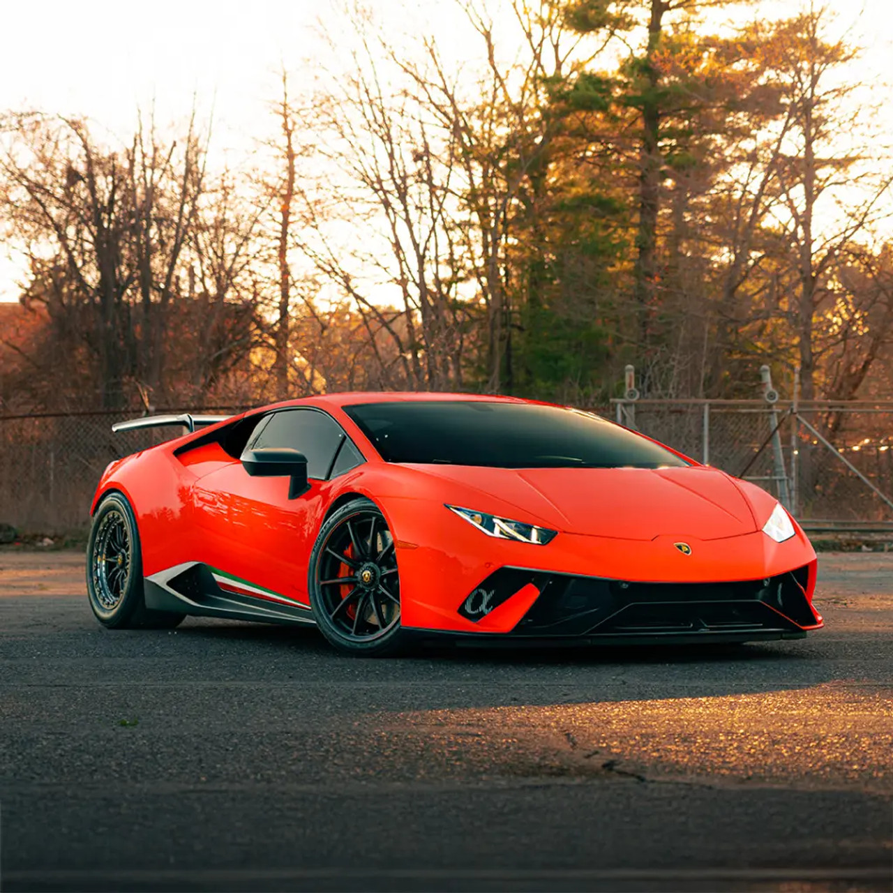 Satin Red’volution applied to a car's side panel, reflecting the environment with a sleek, high-gloss finish.