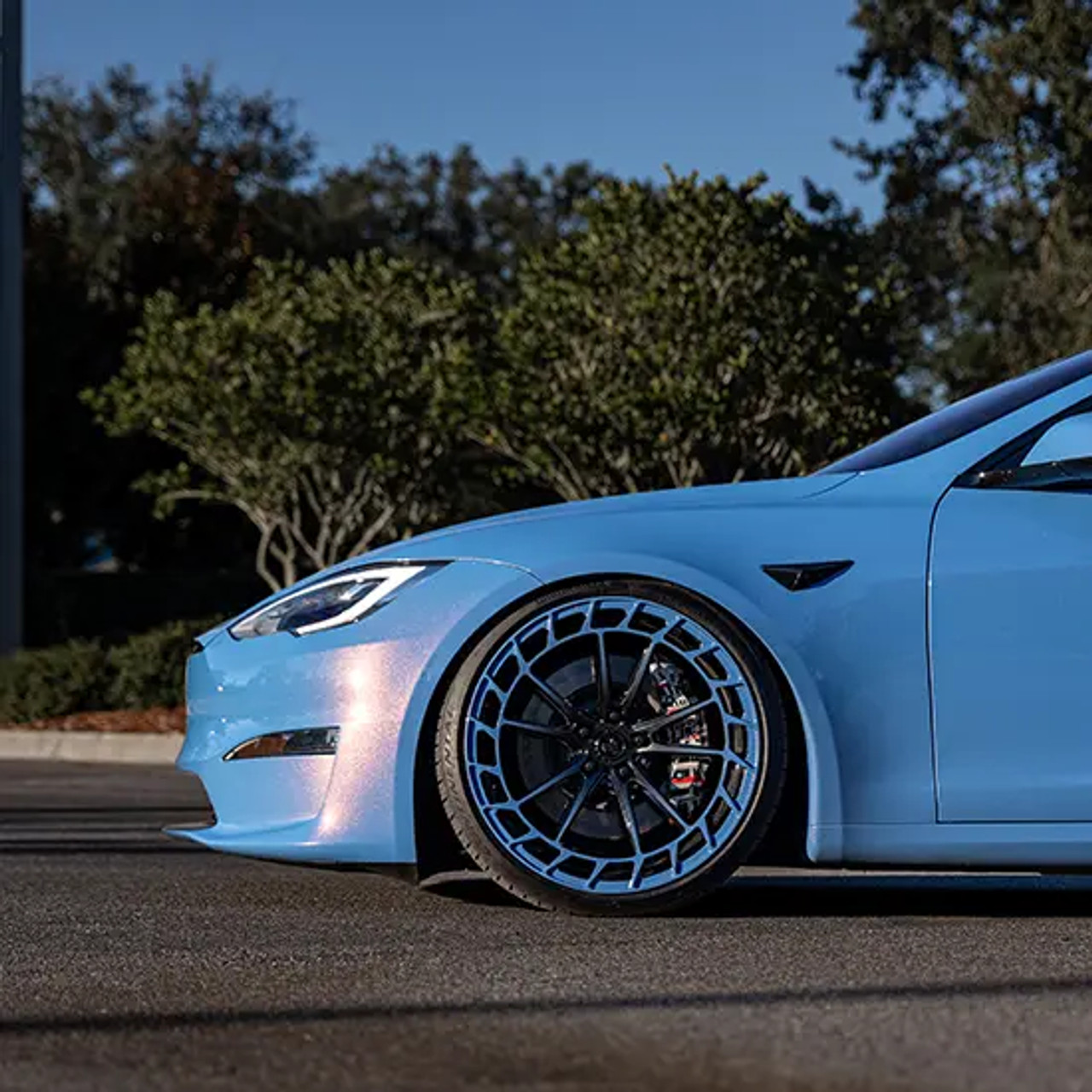 Gloss Yaas Blue PRO installed on a sports coupe side panel under showroom lighting, showcasing its intense color and reflective finish. Gloss Yaas Blue PRO installed on a sports coupe side panel under showroom lighting, showcasing its intense color and reflective finish.