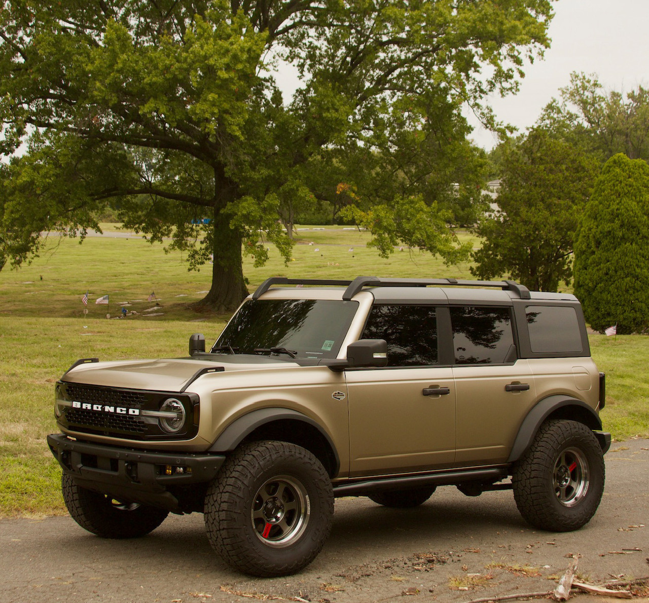 Full Vehicle Image: A full view of a Ford Bronco wrapped in KPMF Matte Dune Metallic, parked outdoors, demonstrating the rugged yet refined appearance of the film on an off-road vehicle. Full Vehicle Image: A full view of a Ford Bronco wrapped in KPMF Matte Dune Metallic, parked outdoors, demonstrating the rugged yet refined appearance of the film on an off-road vehicle.