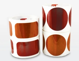 Peel-and-stick prismatic reflectors in SAE red and amber, kiss-cut on a roll in 2" x 3½" rectangles or 3" circles. They conform to the photometric requirements of SAE J594 and replace bolt-on plastic reflectors on trucks, trailers, utility bodies and mobile equipment — with no drilling, no hardware and nothing to snap off.