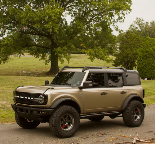 Full Vehicle Image: A full view of a Ford Bronco wrapped in KPMF Matte Dune Metallic, parked outdoors, demonstrating the rugged yet refined appearance of the film on an off-road vehicle. Full Vehicle Image: A full view of a Ford Bronco wrapped in KPMF Matte Dune Metallic, parked outdoors, demonstrating the rugged yet refined appearance of the film on an off-road vehicle.