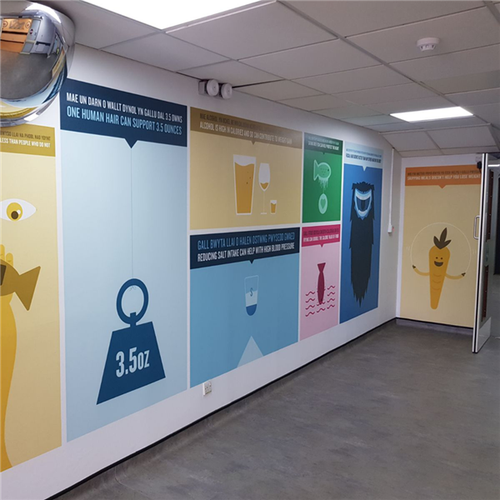 A vibrant full-coverage printed wall wrap applied in a modern office lobby, transforming a plain wall into a bold branded feature using Metamark MD5-GB digital vinyl.