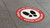 This image features a series of footprint stickers on a floor, designed to enforce social distancing during the Covid-19 pandemic. The stickers are bright and easily noticeable, placed several feet apart, guiding customers on where to stand safely. Made with Mactac PERMACOLOR FloorGrip, the stickers are durable and resistant to wear, demonstrating their effectiveness in maintaining public health guidelines in busy environments.