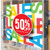 A vibrant storefront window display featuring DryTac Spot-On White M50 vinyl film. The graphics are crisp and eye-catching, applied seamlessly to the glass surface. The dot pattern adhesive technology ensures a bubble-free finish, creating a professional and clean look that enhances the retail signage.