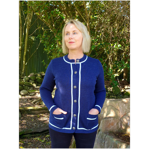 Woman wearing cardigan in Denim Snow with line cut.  Woman wearing cardigan in Denim Snow with line cut.