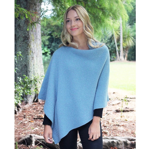 Woman smiling in Mist colour poncho Woman smiling in Mist colour poncho