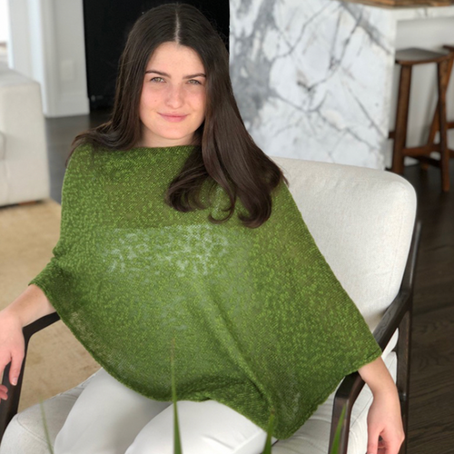 Woman wearing cotton poncho. Colour Fern Woman wearing cotton poncho. Colour Fern