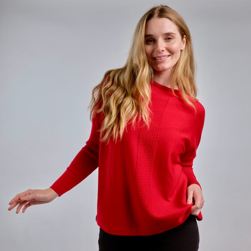 Woman wearing Country Laine - Merino Swing Jumper (CL0075) in the colour Blood Red. Woman wearing Country Laine - Merino Swing Jumper (CL0075) in the colour Blood Red.