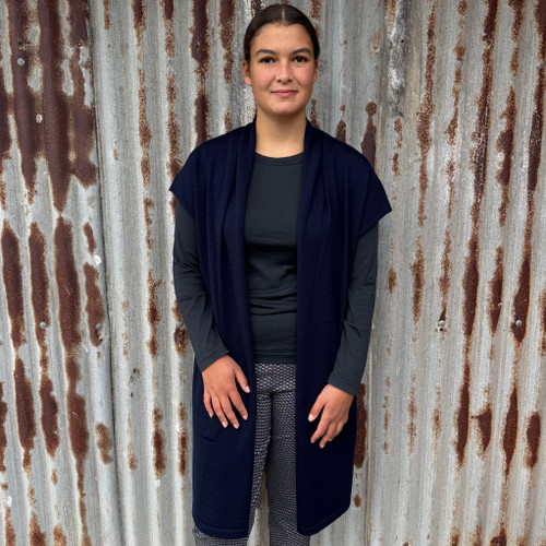 Woman wearing Country Laine - Merino Longline Cap Sleeve Cardigan (CL069) in the colour Navy Woman wearing Country Laine - Merino Longline Cap Sleeve Cardigan (CL069) in the colour Navy