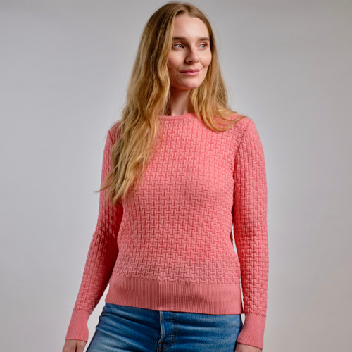 Woman wearing Country Laine - Merino Basketweave Jumper (CL0057) in the colour Peach. Woman wearing Country Laine - Merino Basketweave Jumper (CL0057) in the colour Peach.