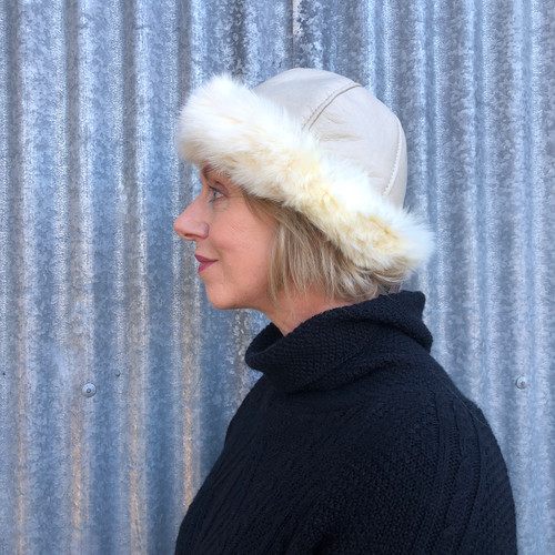 Woman wearing a cream coloured Four Peaks Classic Panelled Lambskin & Possum Fur Hat.
