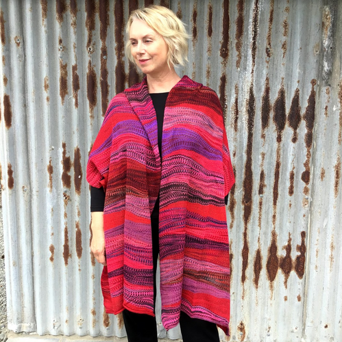 Woman wearing hand dyed wrap. Colour red.