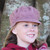 Girl smiling wearing pink Gatsby hat. Girl smiling wearing pink Gatsby hat.