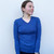Woman wearing vee neck top in colour Moby 